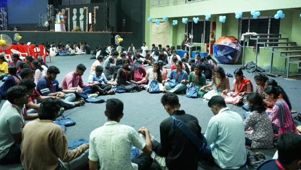 Students holding hands in a circle